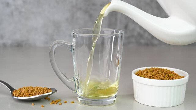 Serving fenugreek tea in a glass cup.