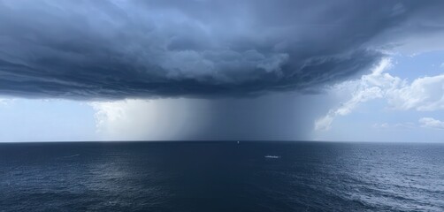 Fototapeta premium Dark Storm Clouds Over Calm Ocean Below Bright Sky Horizon