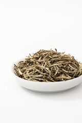 A close-up shot of Chinese tea leaves, against a simple white background.