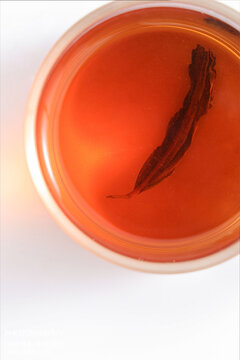A close-up shot of Chinese tea leaves, against a simple white background.