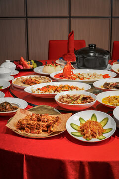The New Year's Eve dinner table in China, filled with a festive and joyful red atmosphere.