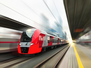 Fototapeta premium Modern train in motion and blur, Russian Railways trains of Moscow and MCC. Moscow Central Circle, metro, underground Red beautiful train in motion. No people blurred train station High quality photo