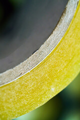 Yellow tape rolls on a work surface