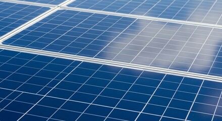 Close up view of multiple blue solar panels reflecting a cloudy sky solar energy