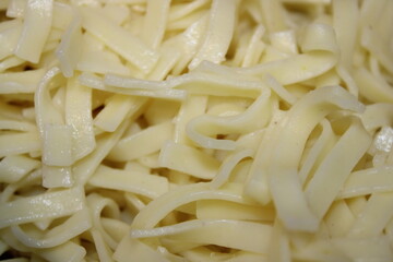 Fettuccine pasta ready for cooking in a kitchen setting during the day