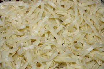 Fresh pasta laid out on a surface ready for cooking with no sauce or toppings added yet