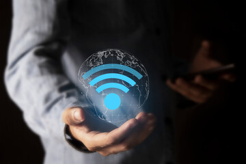 Business communication social network concept.Businessman using laptop with wifi icon.