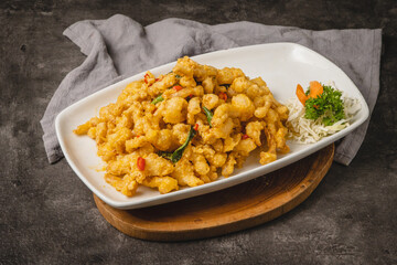 Delicious Asian-style fried chicken dish served on a white plate with garnish.
