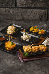 Delicious Assortment of Appetizers and Small Bites on a Rustic Table Setting.