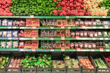 Supermarket showcase of vegetables and fruits. Vegetarian section in a modern soutzermarket, beautiful display of fresh products for vegetarians. High quality photo