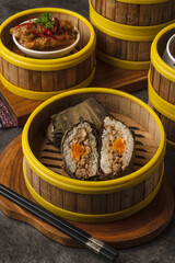 Delicious Chinese Dim Sum Sticky Rice Dumplings in Bamboo Steamer Baskets.