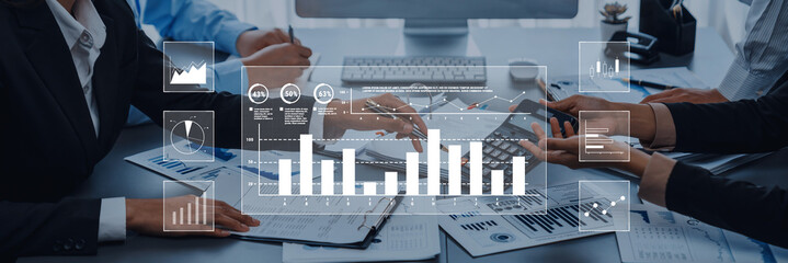 A business team engages in collaborative financial analysis, utilizing modern technology to visualize data through charts and graphs in a professional office environment. Trope