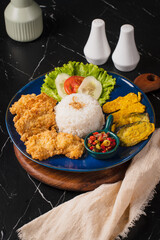 Delicious Fried Chicken Meal with Rice and Vegetables.