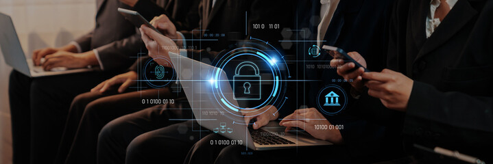 A group of professionals using digital devices in a modern office setting. A lock icon symbolizes the importance of cybersecurity and data protection in today business environment. Trope