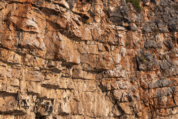 rock; rock face; rockwall; rugged; abstract; amber; background; boulder; brown; cave; cliff; cliff side; closeup; color; colors; cracks; crevices; design; detail; earthy; erosion; face; formation; fos