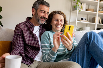 Mature couple enjoying technologies and togetherness at home