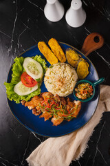 Delicious Indonesian Grilled Chicken with Rice and Sides.