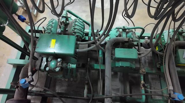 Compressors, tubes and other elements in industrial refrigeration installation for huge refrigeration chambers.