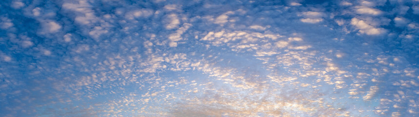 Tranquil sunset sky panorama with clouds, peaceful nature background and copy space
