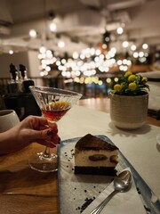 going out in the city with friends to a pub with alcoholic drinks and a delicious, appetizing cake with a bright background