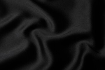 Black silk satin. Shiny smooth fabric. Soft folds. Luxury background with space for design. Flat table, top view