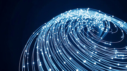 Glowing blue fiber optic light trails in a swirling pattern on a dark background