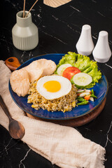 Delicious Nasi Goreng with Fried Egg and Fresh Vegetables.
