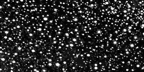 A field of scattered bright white specks against a dark black background