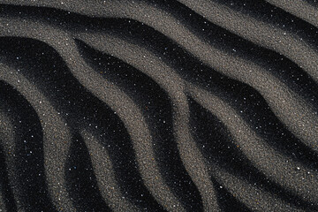 Black volcanic desert sand creating mesmerizing ripple effects