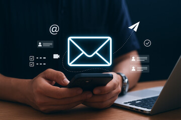 Digital marketer using email marketing tools on laptop and smartphone, sending newsletters and analyzing campaign performance to engage subscribers and grow business through personalized content