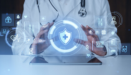 Doctor interacting with futuristic digital medical interface showing healthcare icons and shield symbol on hologram background for protection concept.
