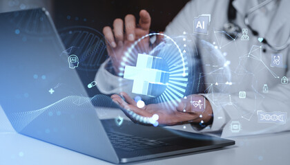Futuristic healthcare technology concept with hologram interface over laptop and doctor background representing digital medical innovation concept.