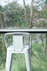 The white chair in the cafe is decorated with a natural view.