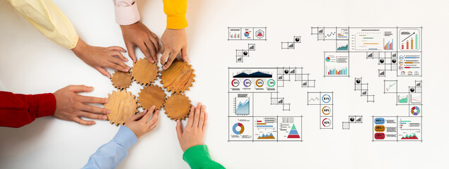 A diverse team engages in collaborative strategy planning using wooden gears and visual business charts, representing teamwork and effective analysis in a modern office environment. Trope