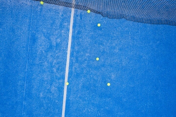 Sport scene on a blue padel tennis court.