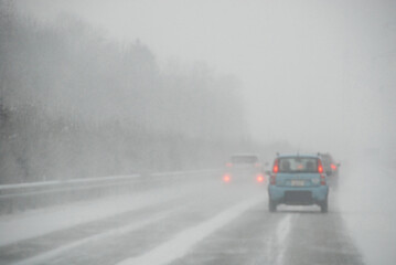 Fototapeta premium Cars on a winter road during fog