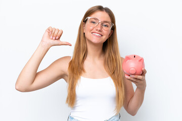 Young pretty blonde woman holding piggy bank isolated on white background proud and self-satisfied