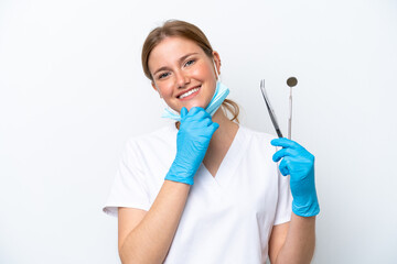 Fototapeta premium Dentist caucasian woman holding tools isolated on white background happy and smiling