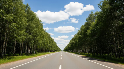 a straight road with a very beautiful view of the clouds, lots of trees on the right and left sides