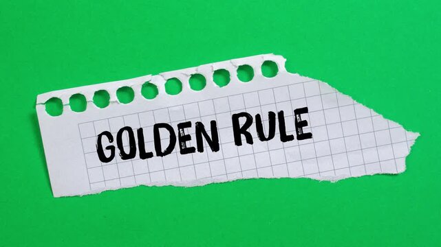 Golden rule message writing on ripped torn paper background