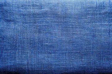 A close-up view shows a blue fabric with a noticeable texture. Light reflects softly on its surface