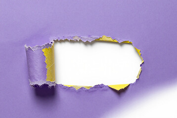 Torn piece of purple paper with a white background.