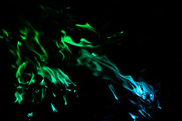 Vibrant Green and Blue Smoke Against a Dark Background