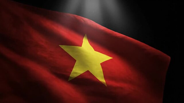 A red fabric flag with a central yellow five-pointed star illuminated by shafts of light from above set against a dark background