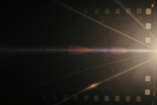 Film strip with a bright light shining through it. - Powered by Adobe