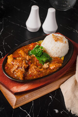 Sizzling Chicken with Rice on a Hot Plate.