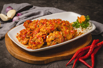 Spicy Fried Chicken with Chili Sauce on White Plate.