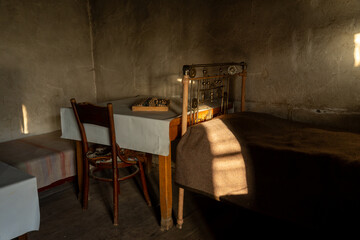 Rustic bedroom corner with abacus and wooden chair in warm sunlight
