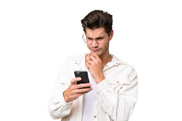 Fototapeta premium Young handsome caucasian man over isolated background thinking and sending a message