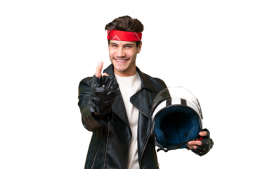 Young caucasian man with a motorcycle helmet over isolated background doing coming gesture
